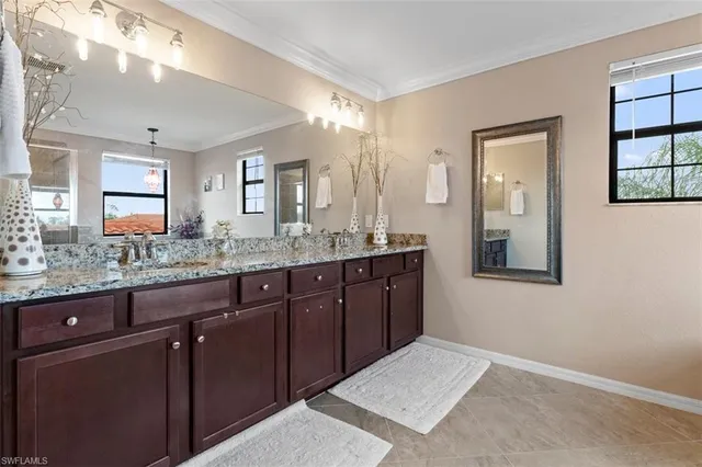 a spacious bathroom with a granite countertop sink mirror and double