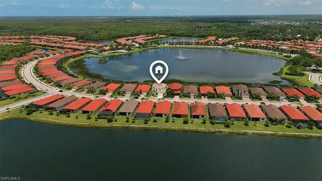 an aerial view of a house with garden space and lake view