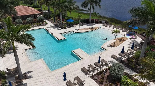 a living room with furniture a large window and wooden floor
