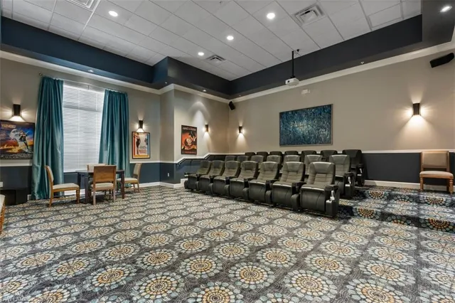 a dining hall with stainless steel appliances a dining table and chairs