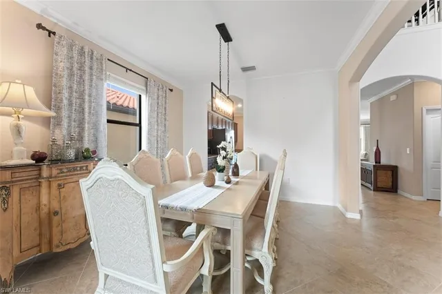 a view of a dining room with furniture and a chandelier