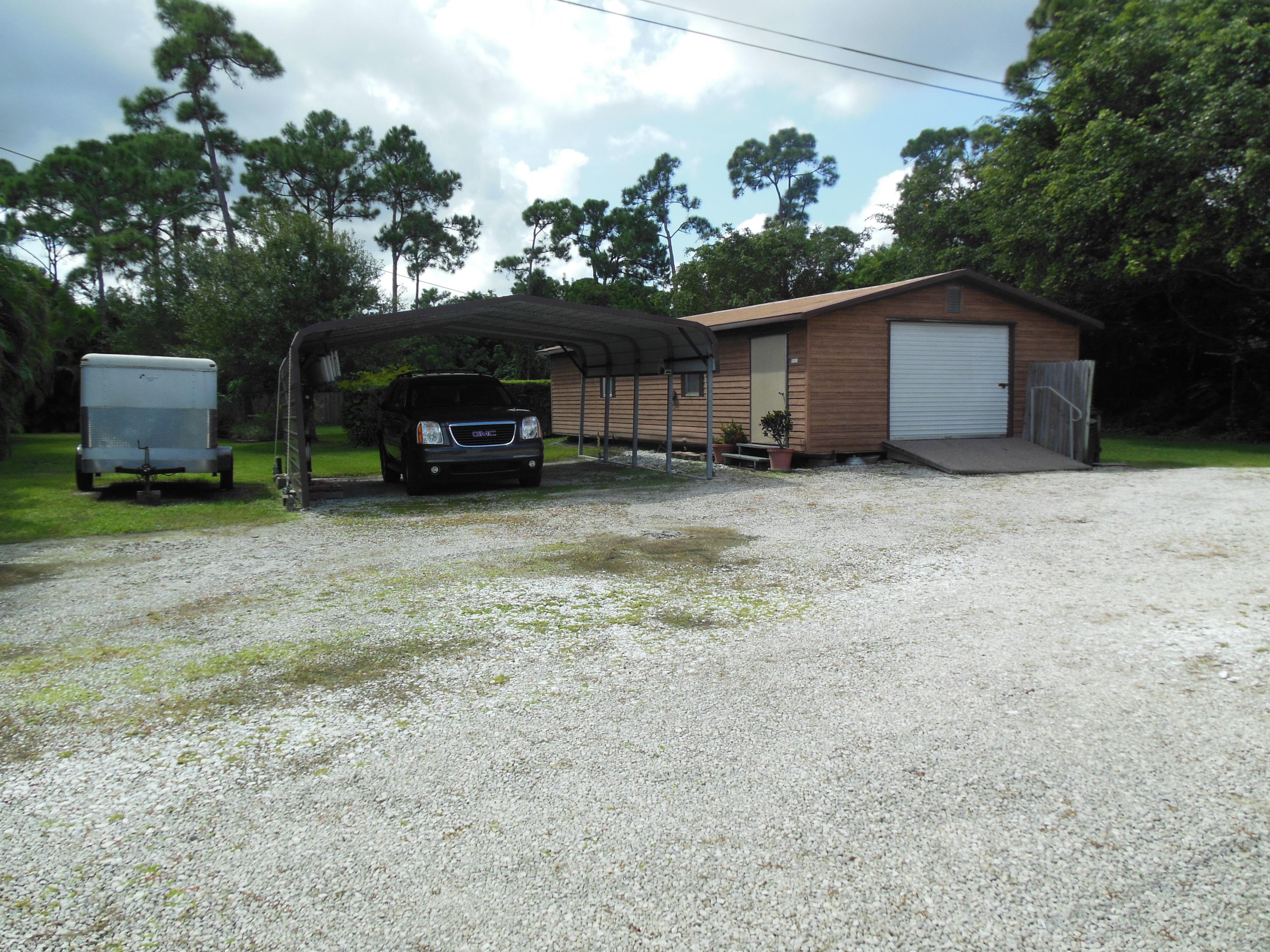 5717 Raintree Trail Fort Pierce, FL 34982 - Photo 4 of 24 Carport and Large Shed