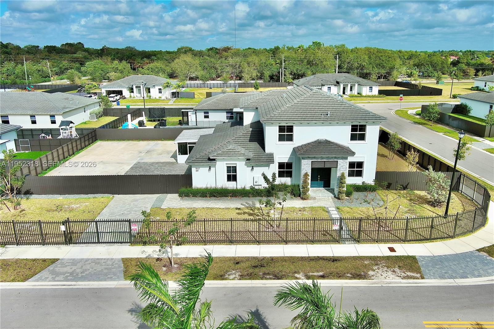 16925 Southwest 289th Terrace Homestead, FL 33033 - Photo 54 of 58 an aerial view of residential houses with outdoor space and parking