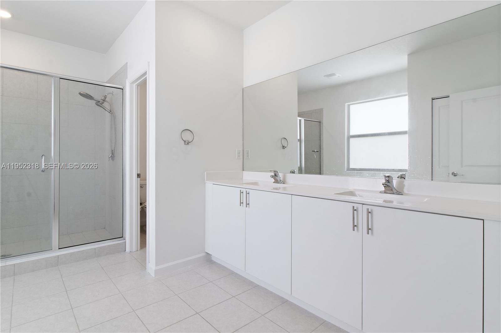 16925 Southwest 289th Terrace Homestead, FL 33033 - Photo 9 of 58 a bathroom with a double vanity sink and mirror