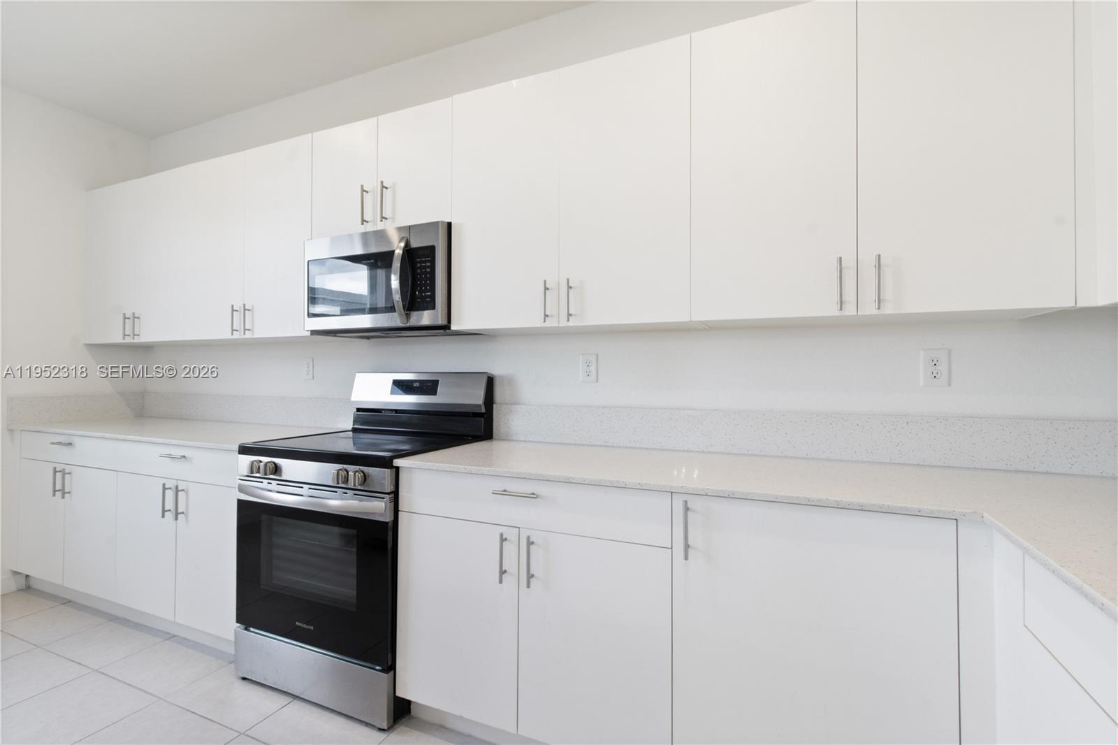 16925 Southwest 289th Terrace Homestead, FL 33033 - Photo 10 of 58 a kitchen with white cabinets and stainless steel appliances
