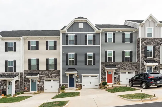 a front view of a residential apartment building with a yard