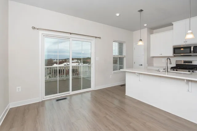 a view of a kitchen with a sink and dishwasher cabinets