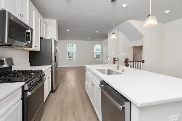a kitchen with a sink stove and microwave