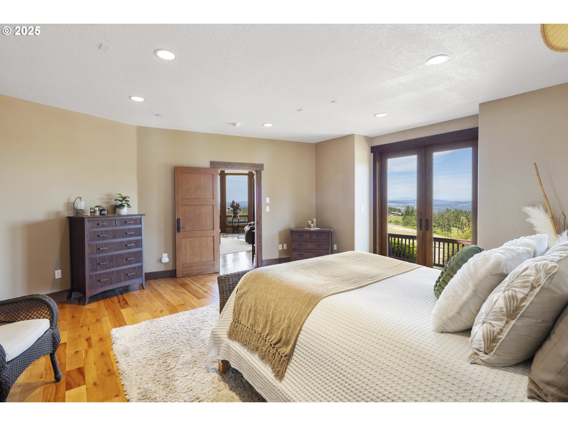 21250 Southwest Jaquith Road Newberg, OR 97132 - Photo 20 of 48 a bedroom with a bed closet and a flat tv screen