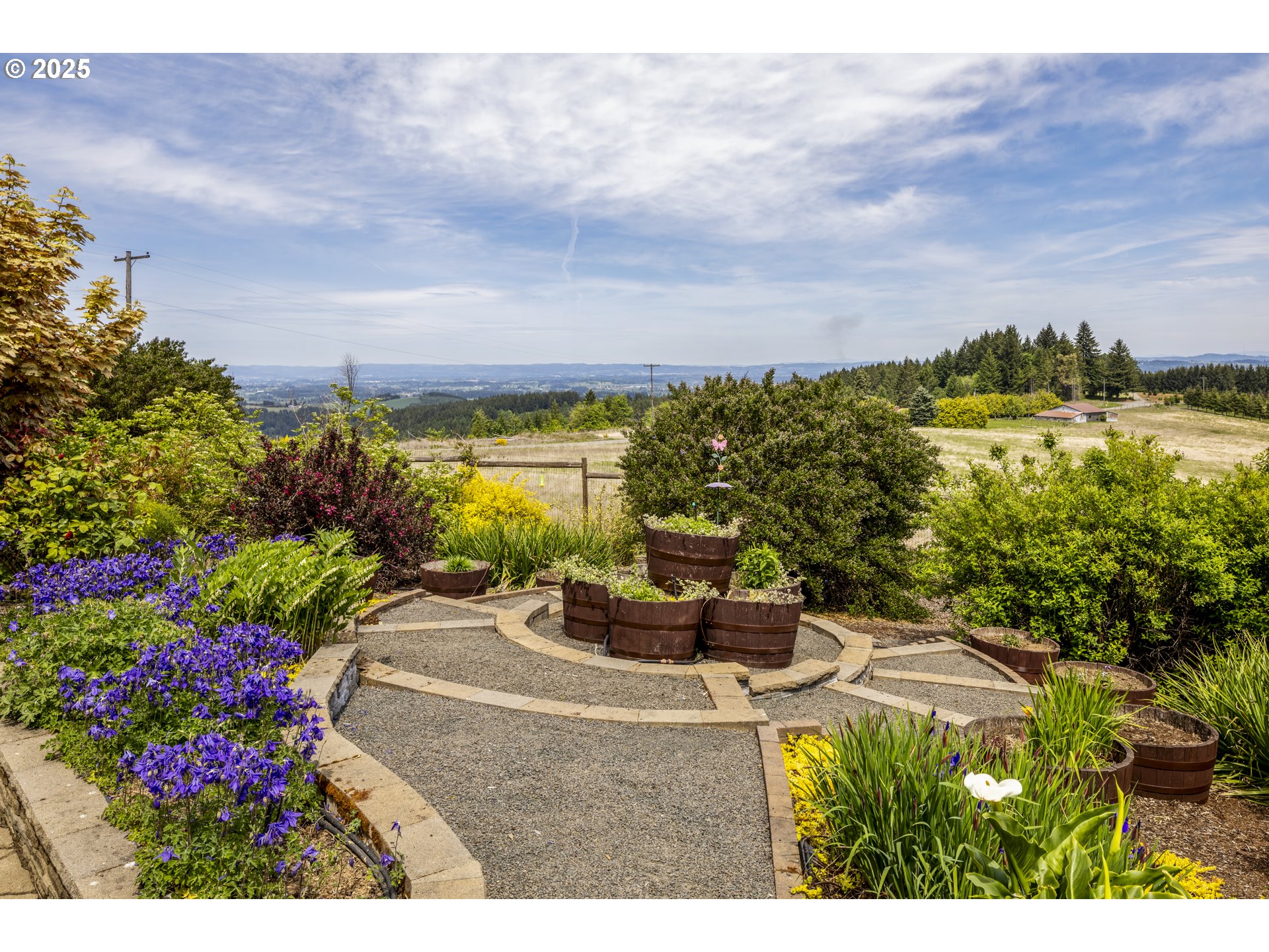 21250 Southwest Jaquith Road Newberg, OR 97132 - Photo 44 of 48 a view of a garden with a bench in a garden