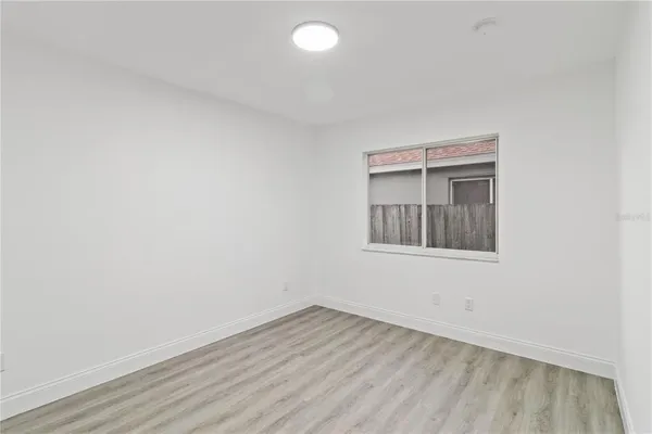 a view of an empty room and wooden floor