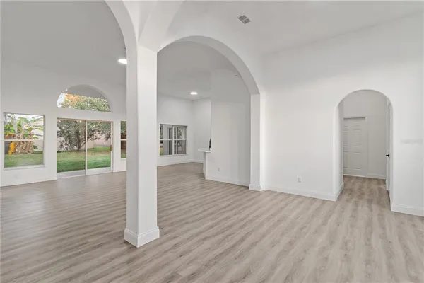 a view of a room with wooden floor and window