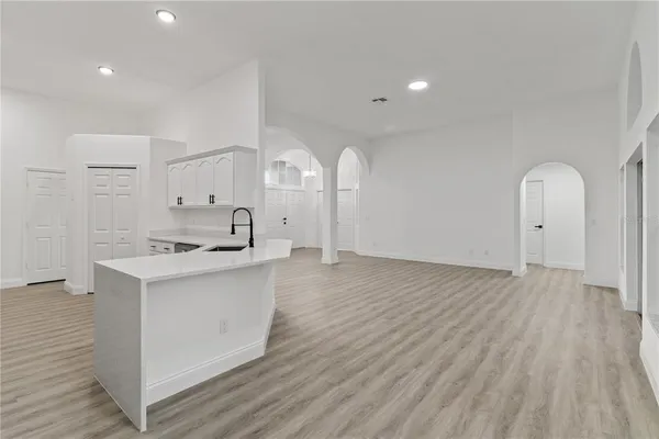 a kitchen with stainless steel appliances a refrigerator sink and cabinets