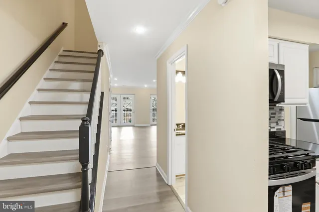 a view of a livingroom with wooden floor and stairs