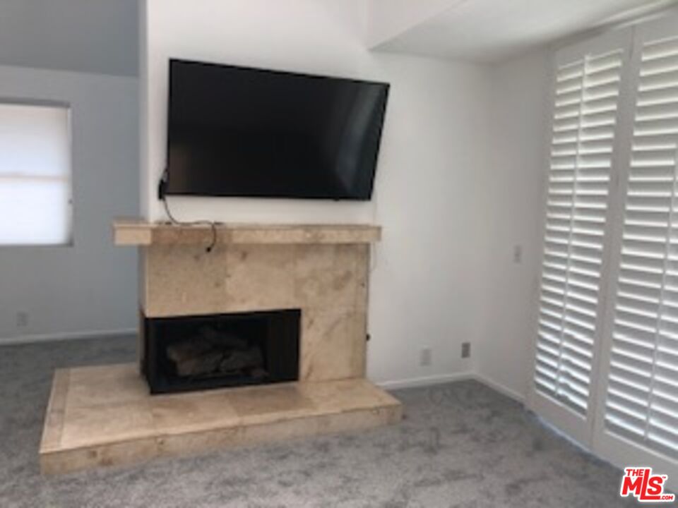 4510 Antigua Way Oxnard, CA 93035 - Photo 9 of 12 a living room with a fireplace and a flat screen tv