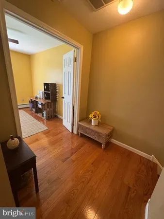 a view of a room with workspace and a mirror