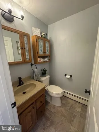 a bathroom with a sink a toilet and mirror