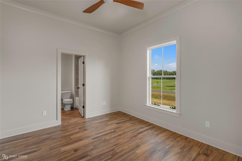 219 Marble Place Haughton, LA 71037 - Photo 23 of 29 Spacious room featuring wood-finish flooring, a ceiling fan, and crown molding