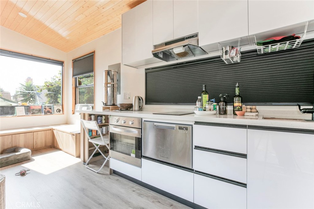 7553 McGroarty Street Tujunga, CA 91042 - Photo 22 of 38 a kitchen with a sink stove and cabinets