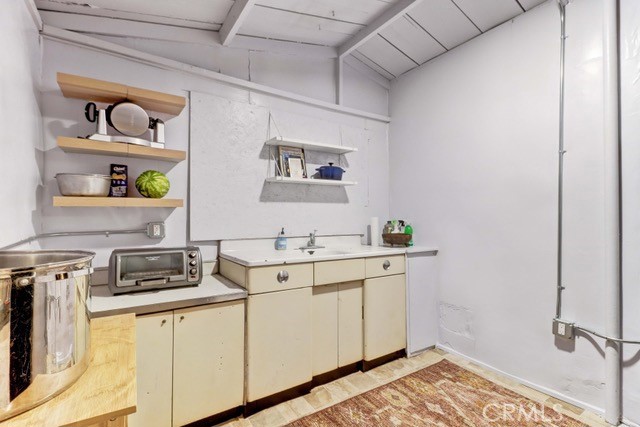 7553 McGroarty Street Tujunga, CA 91042 - Photo 9 of 38 a kitchen with a sink and cabinets