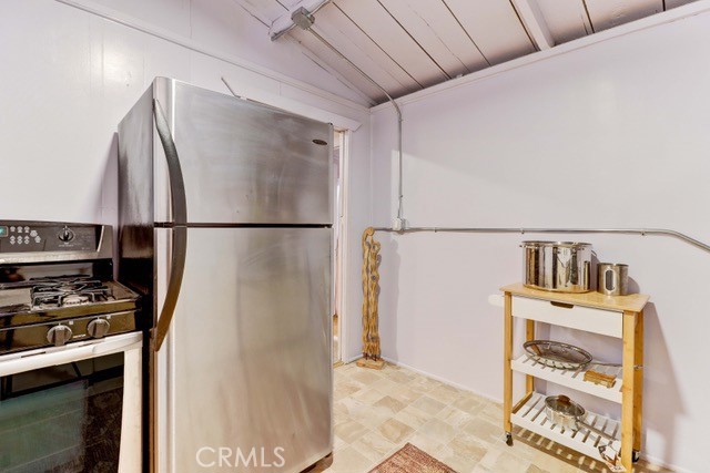 7553 McGroarty Street Tujunga, CA 91042 - Photo 10 of 38 a kitchen with stainless steel appliances a refrigerator and a stove top oven