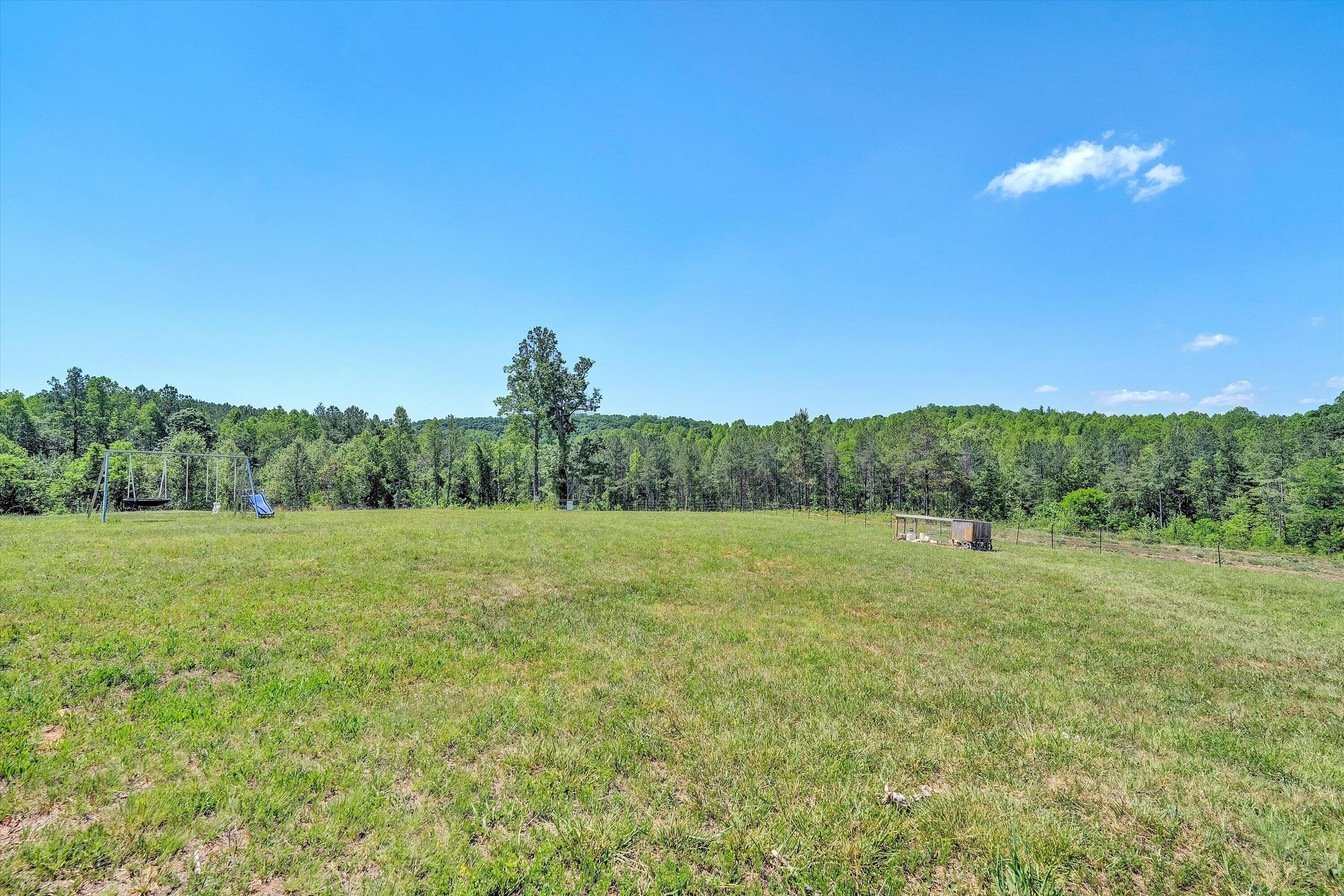 180 Thompson Ridge Circle Ferrum, VA 24088 - Photo 65 of 74 a view of a big yard with an outdoor space and seating