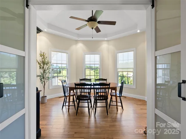 a view of a dining room with furniture and wooden floor