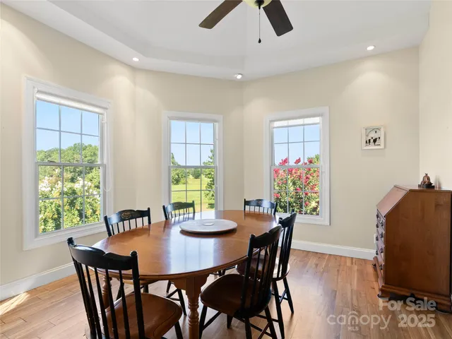 a view of a dining room with furniture and a potted plant