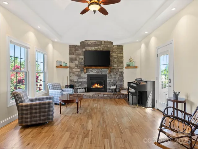 a living room with furniture fireplace and flat screen tv