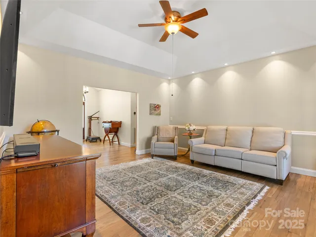 a living room with furniture and a wooden floor