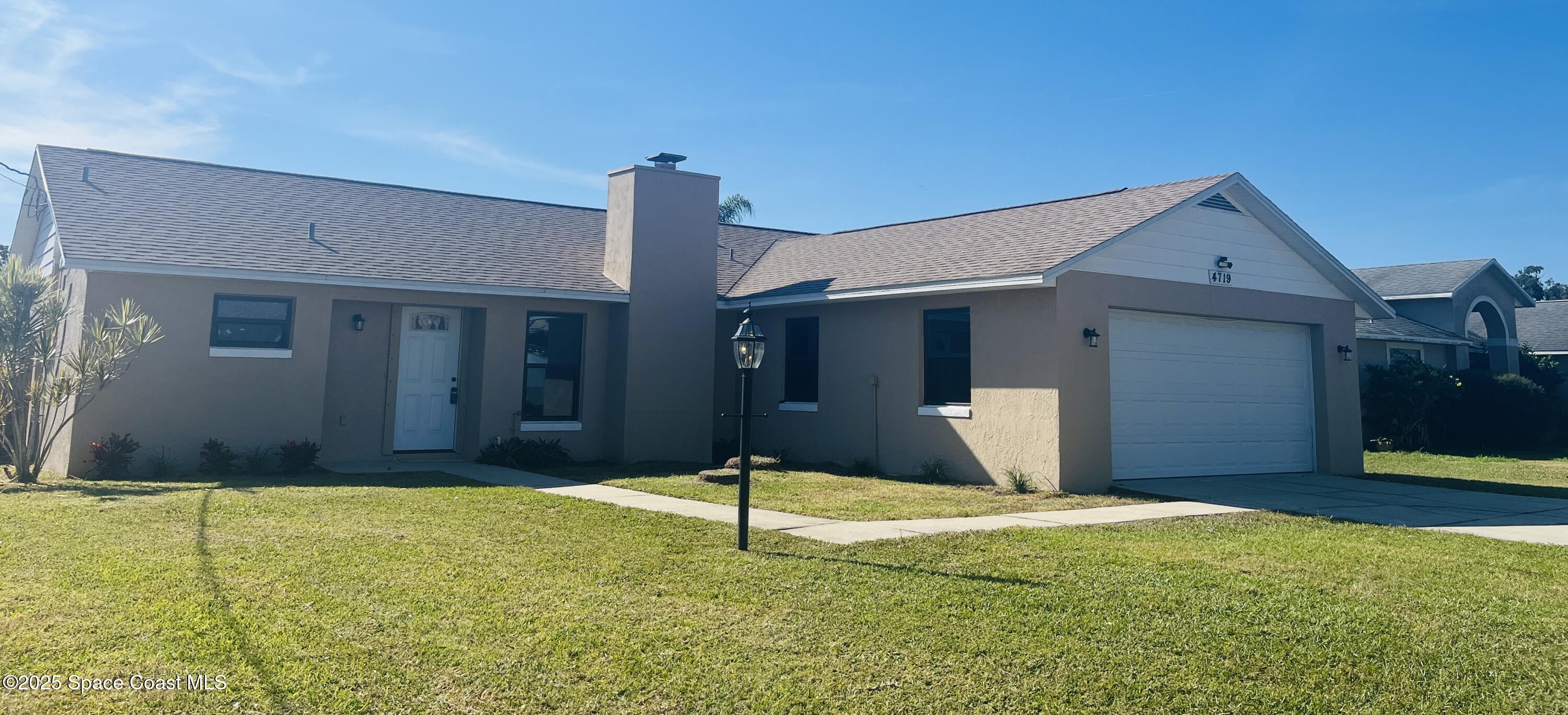 a house view with swimming pool in front of it