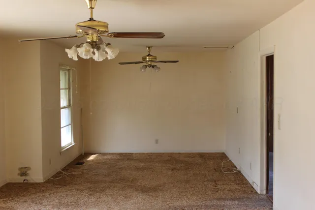 a view of a chandelier fan and wooden floor