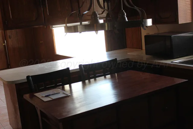 a view of a living room with furniture and a window