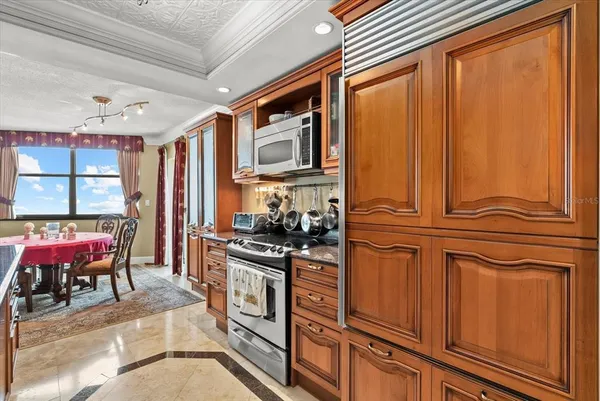 a kitchen with stainless steel appliances granite countertop a refrigerator and microwave