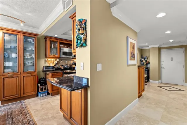a kitchen with stainless steel appliances granite countertop a refrigerator and a stove top oven
