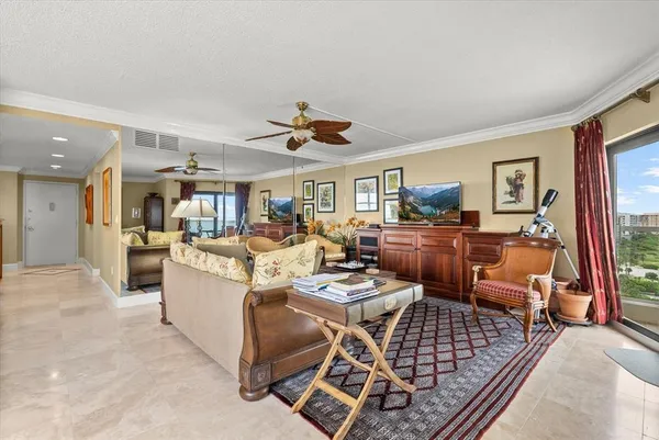 a living room with furniture kitchen and a table
