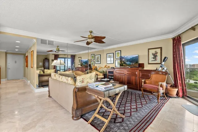 a living room with furniture kitchen and a table