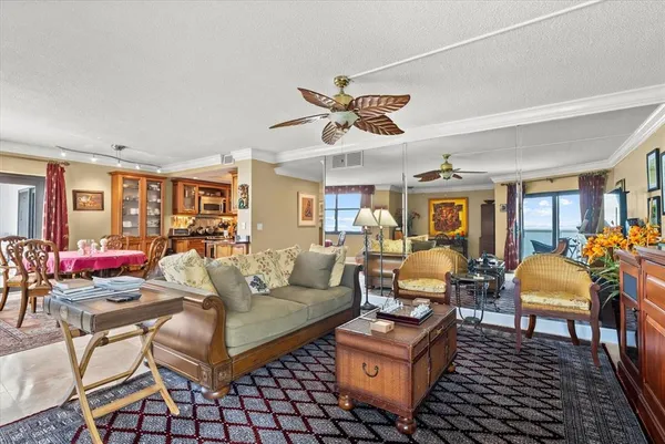 a living room with furniture a dining table and a piano table