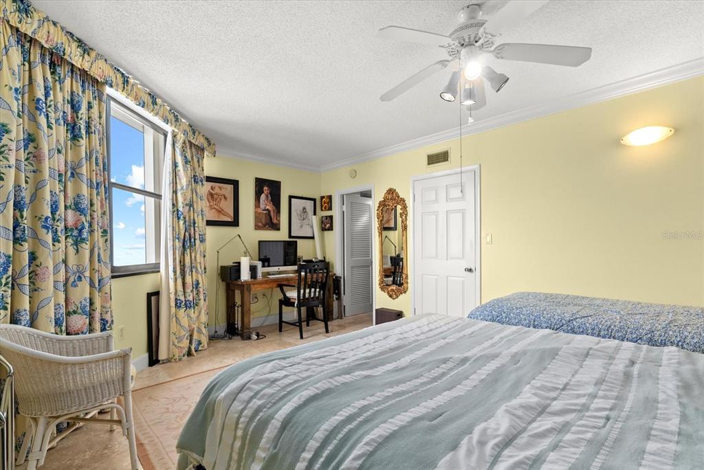 1000 Longboat Club Road, Unit 1001 Longboat Key, FL 34228 - Photo 20 of 40 a bedroom with a bed and a chandelier