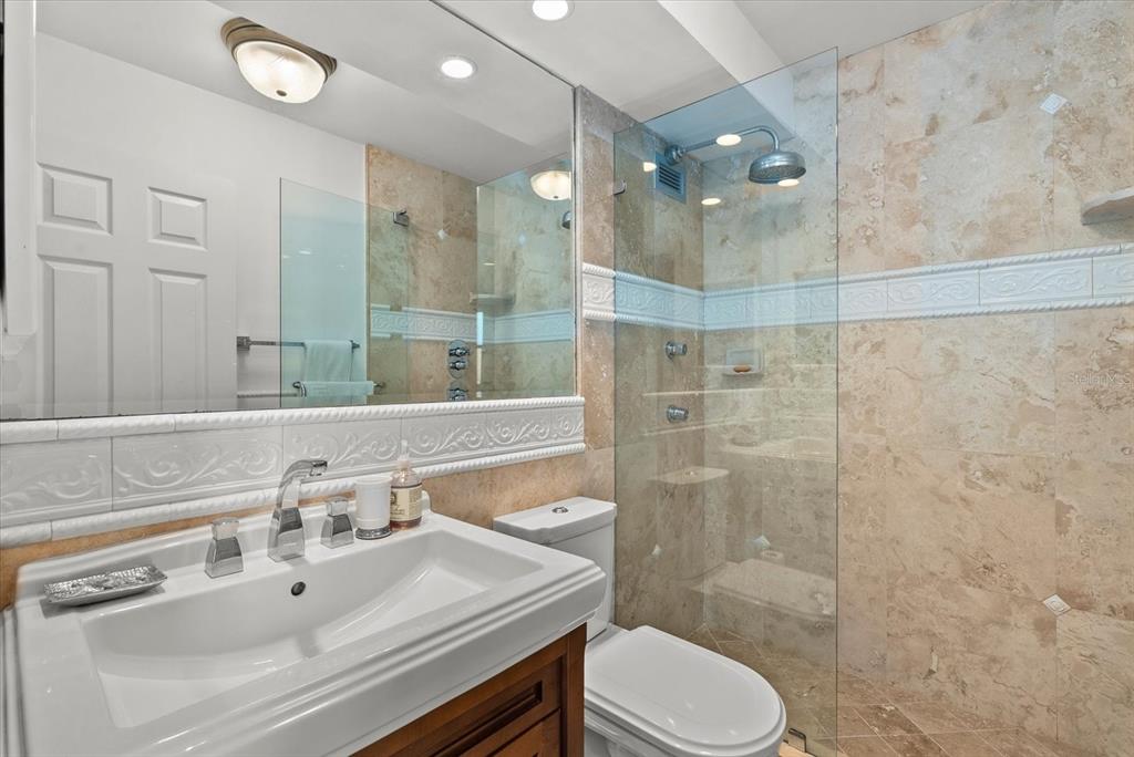 1000 Longboat Club Road, Unit 1001 Longboat Key, FL 34228 - Photo 21 of 40 a bathroom with a sink vanity granite toilet and shower
