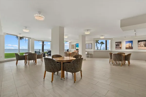a dining room with furniture and a kitchen view
