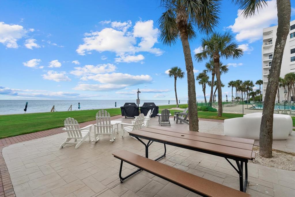 1000 Longboat Club Road, Unit 1001 Longboat Key, FL 34228 - Photo 29 of 40 a view of a patio with a table and chairs
