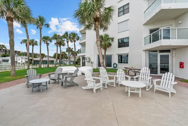 a view of a patio with a table and chairs