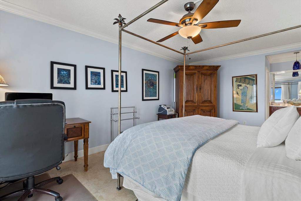 1000 Longboat Club Road, Unit 1001 Longboat Key, FL 34228 - Photo 5 of 40 a bedroom with a bed and a chandelier