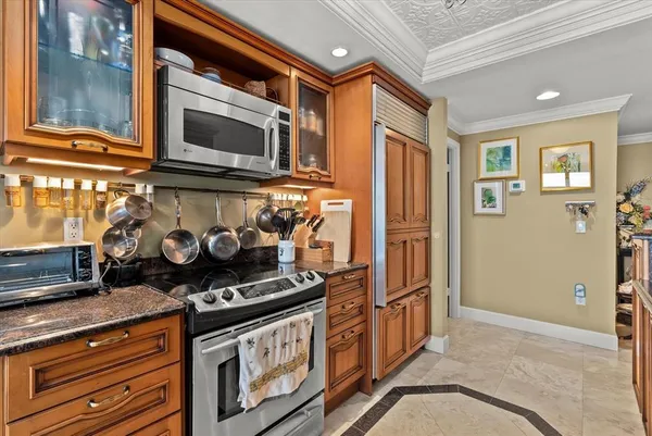 a kitchen with stainless steel appliances granite countertop a stove and a microwave