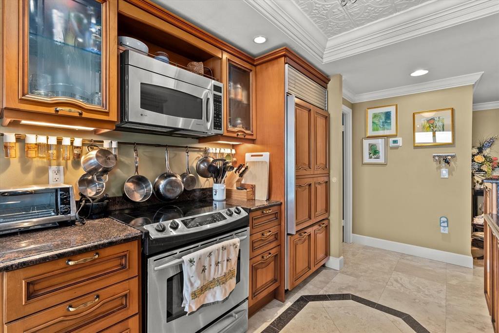 1000 Longboat Club Road, Unit 1001 Longboat Key, FL 34228 - Photo 7 of 40 a kitchen with stainless steel appliances granite countertop a stove and a microwave