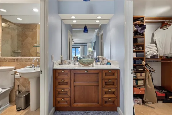 a bathroom with a sink a vanity and a mirror