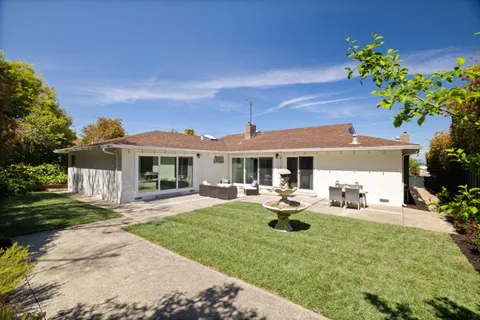 a front view of a house with garden and porch