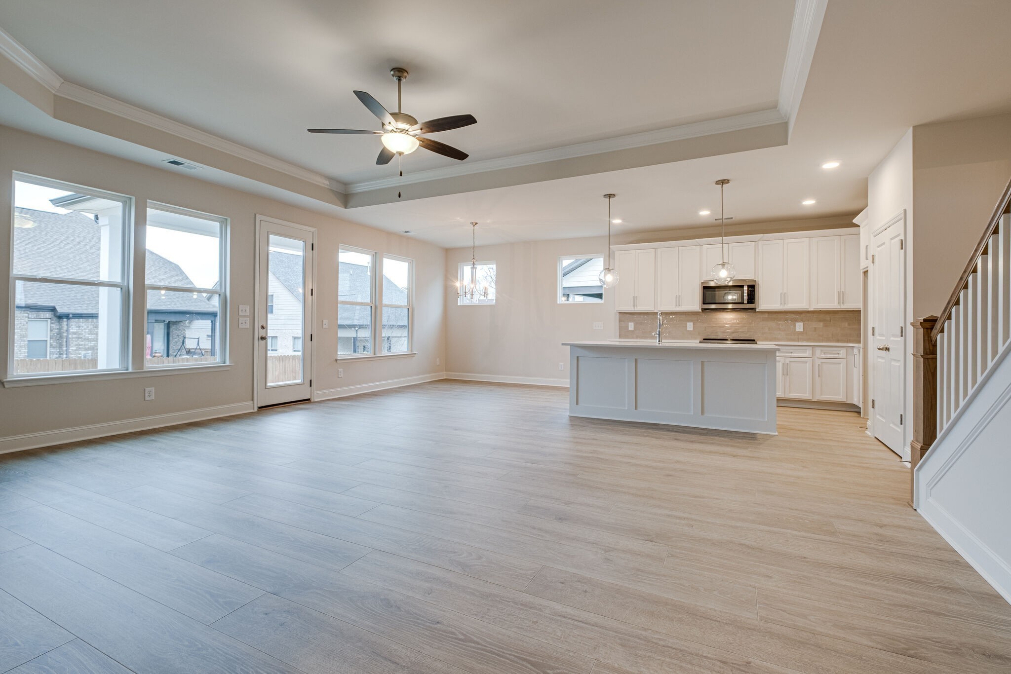 3017 Fanshaw Road Smyrna, TN 37167 - Photo 11 of 39 a view of an empty room with wooden floor and a kitchen