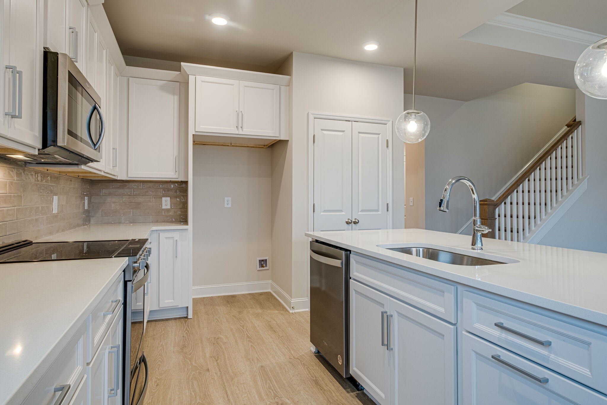 3017 Fanshaw Road Smyrna, TN 37167 - Photo 13 of 39 a kitchen with a sink dishwasher a stove and a refrigerator with wooden floor